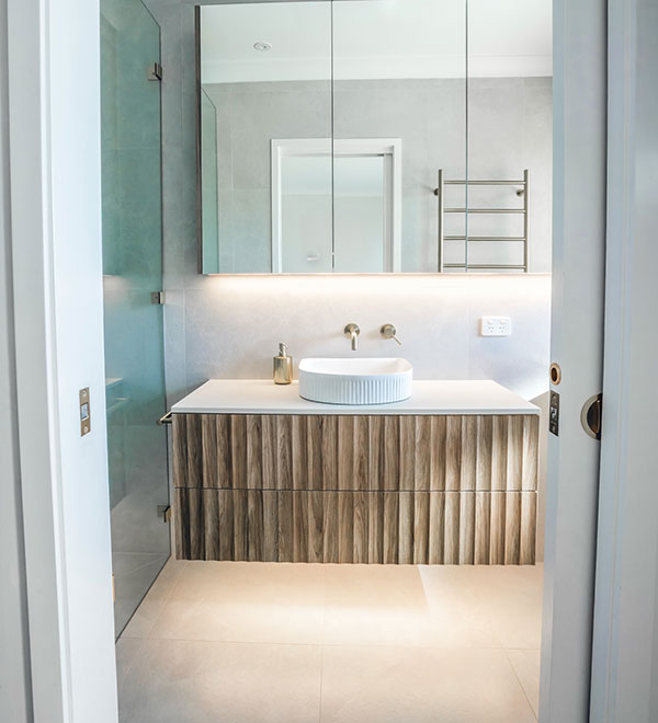 Elegant Canberra bathroom renovation with glass shower and cabinetry