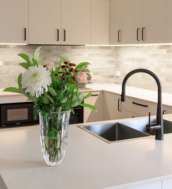 Modern kitchen renovation in Canberra featuring custom cabinetry, stone benchtops and functional storage solutions