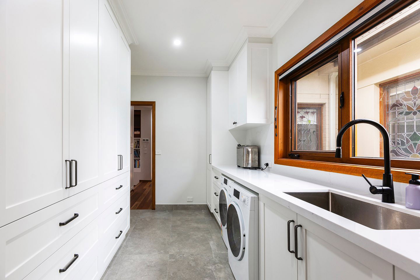 Compact and functional laundry makeover in Canberra featuring smart storage and durable finishes by Timeless Projects.