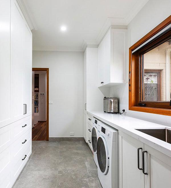 Compact and functional laundry makeover in Canberra featuring smart storage and durable finishes by Timeless Projects.